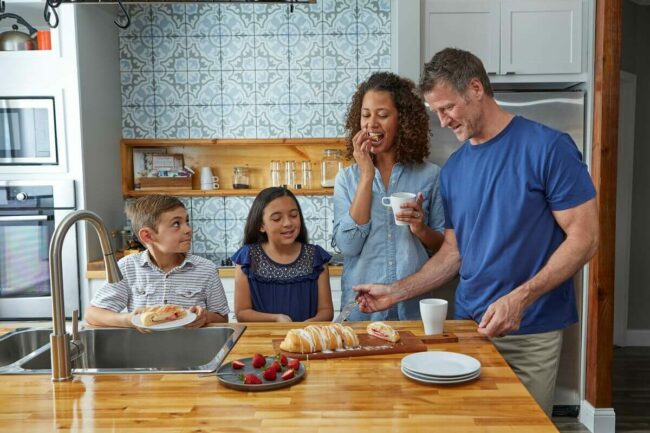 Family in kitchen eating a Butter Braid Pastry